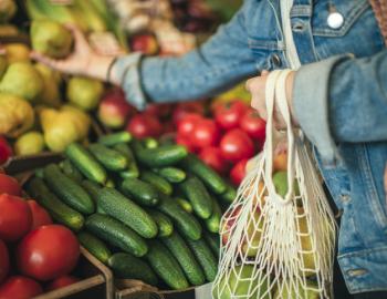 women in jean jacket shopping at farmers market