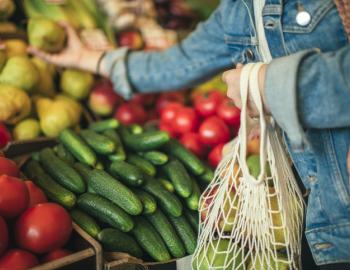 women in jean jacket shopping at farmers market