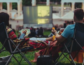 couple watching outdoor movie in a park