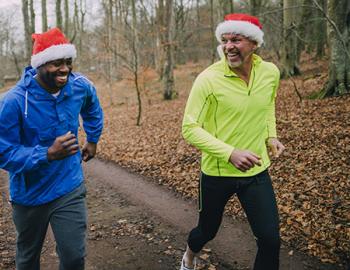 People running in a race with Santa hats on