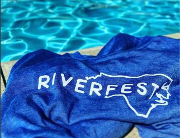 Riverfest towel next to the pool