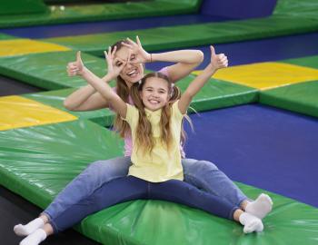 mom and daughter in a trampoline park