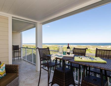 Oceanfront deck with wine looking over beach Oceanfront deck with wine looking over beach
