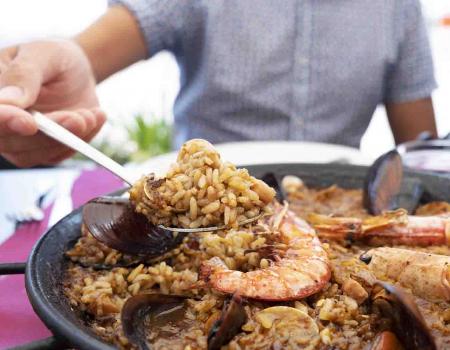 Someone enjoying fresh seafood at a restaurant