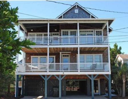 A rear exterior view of the two open balconies on Brown, a vacation rental home near Downtown Wrightsville Beach, N.C