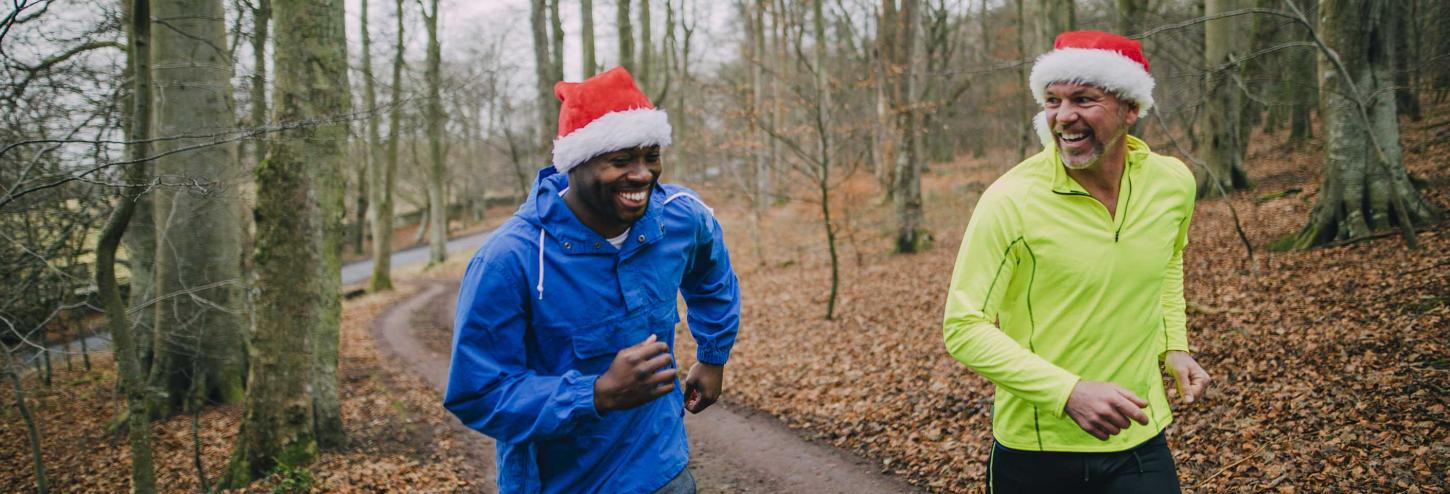 People running with Santa hats on