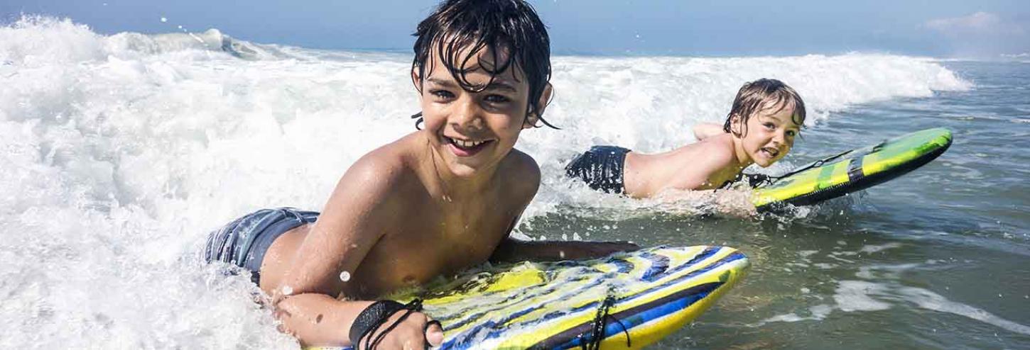 Kids riding the waves at Kure Beach