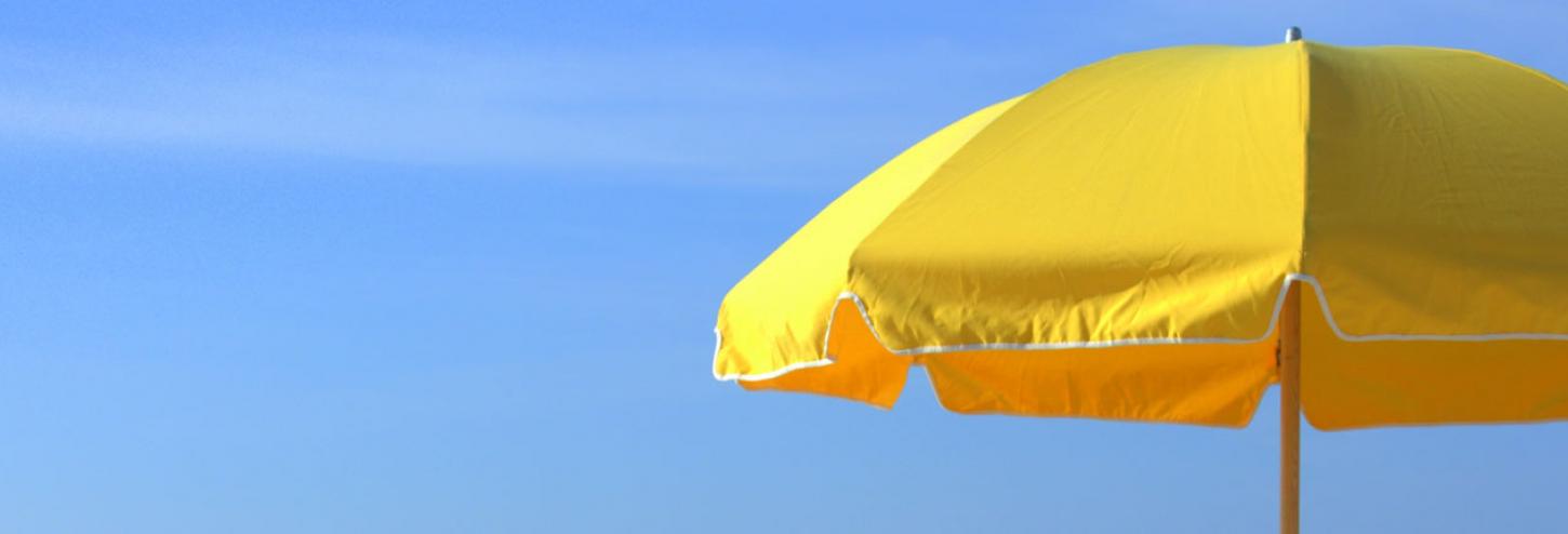 yellow umbrella against a blue sky