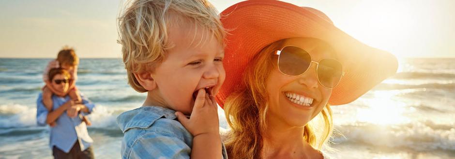 Mom and son enjoying the sun at the beach