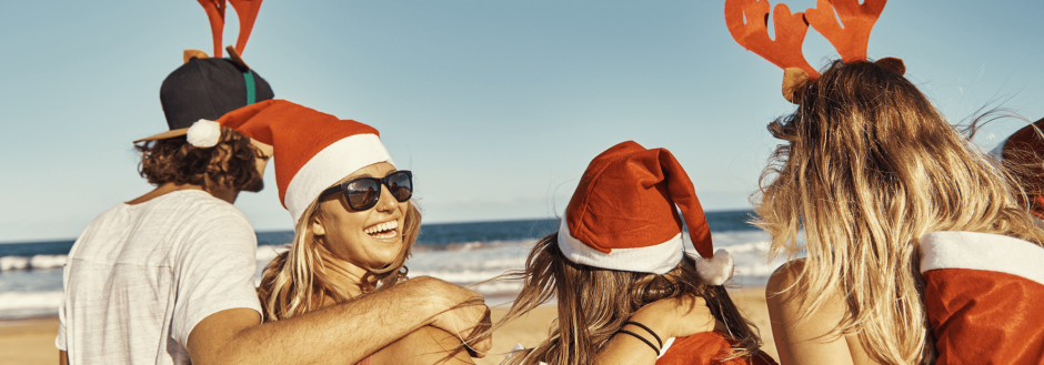 friends enjoying christmas at the beach together