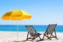 beach chairs with yellow umbrella