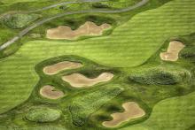 Aerial of golf course putting green and sand traps