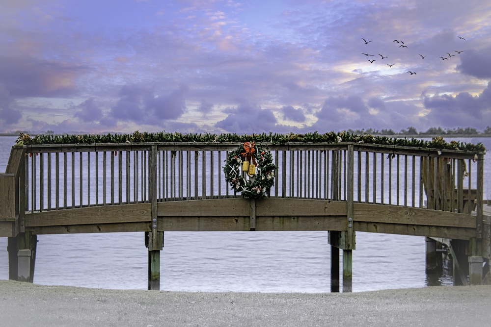 Christmas wreath on bridge by beach in north carolina