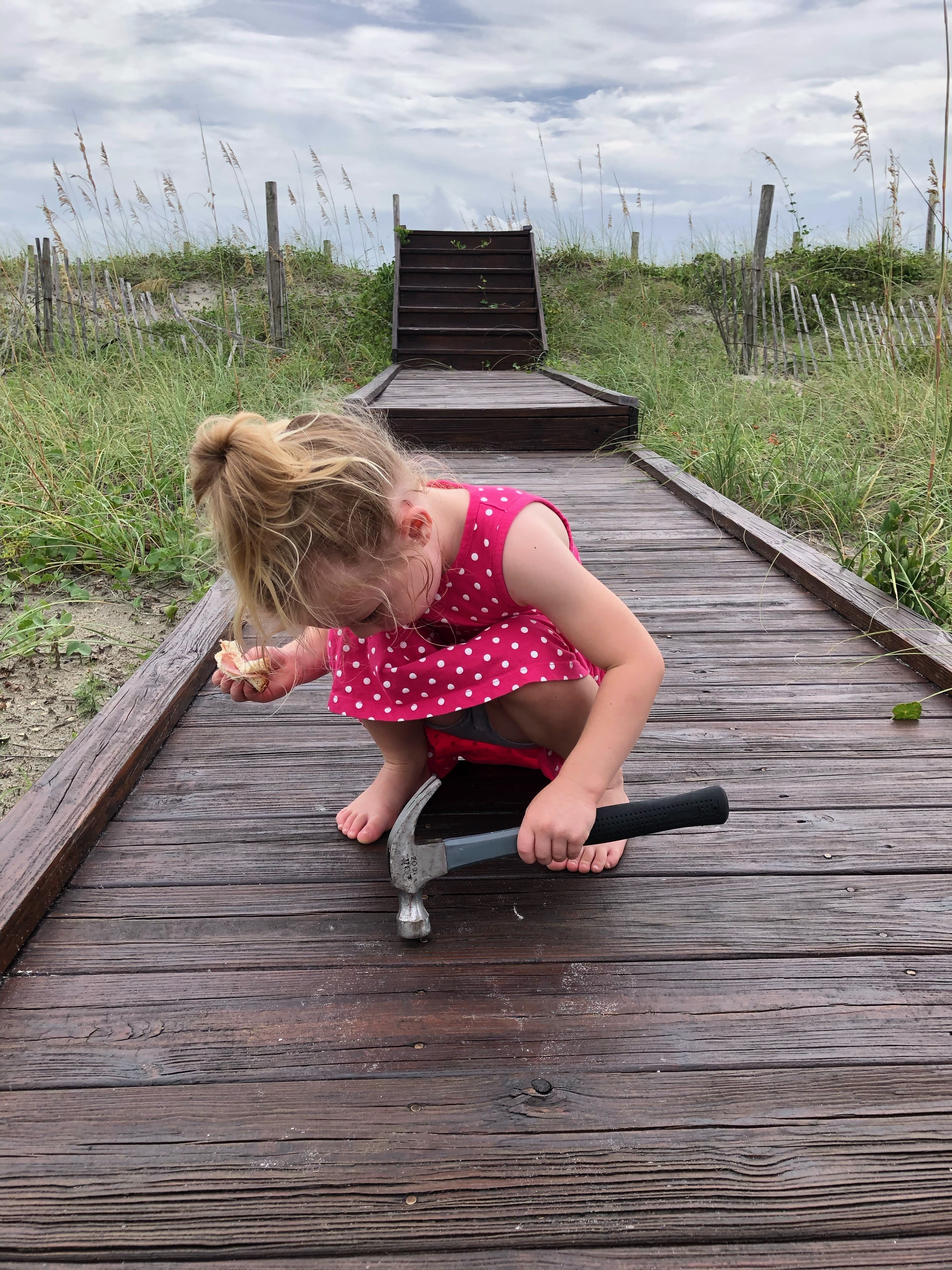 Jason's Daughter Emma working on a boardwalk while on vacation at one of Bryant Real Estate's Rentals