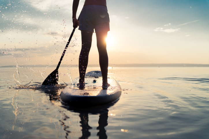 A man stands on a SUP board