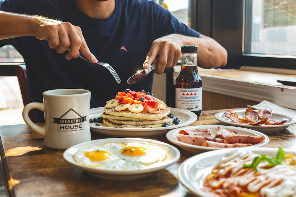 Person at a breakfast restaurant enjoying pancakes 