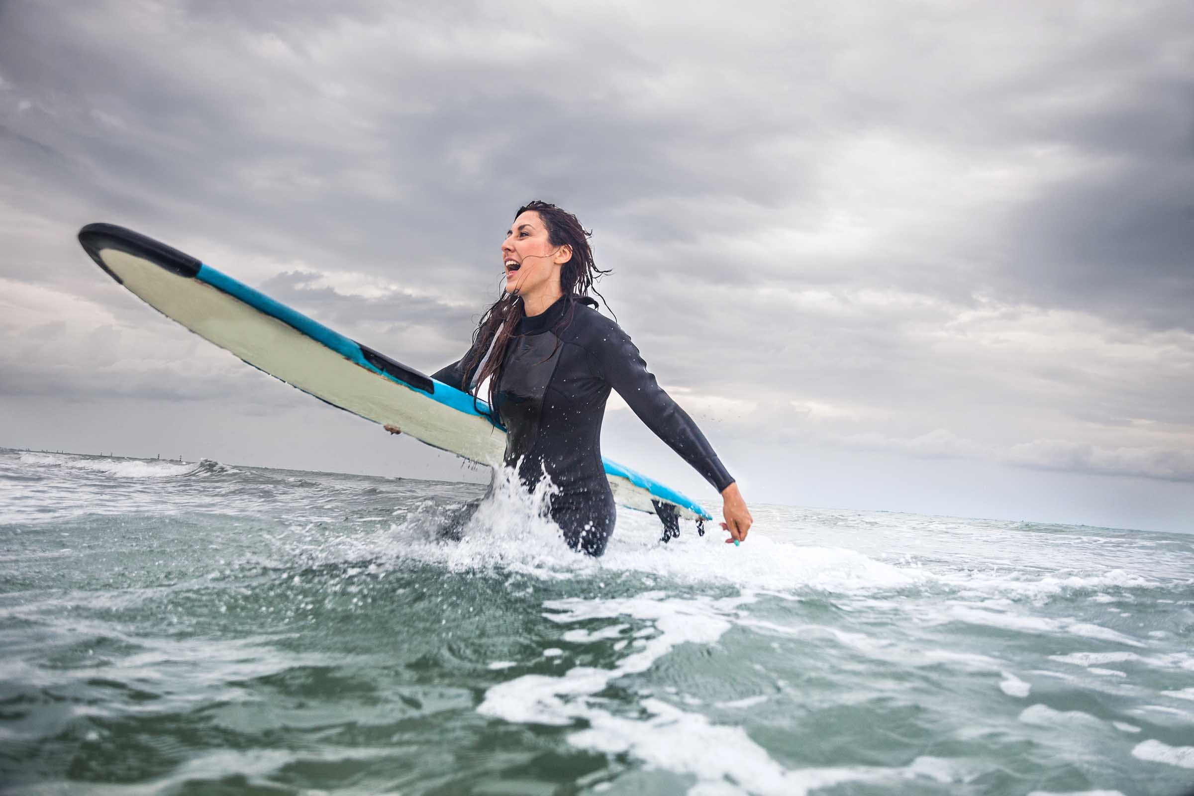 Woman in water with longboard